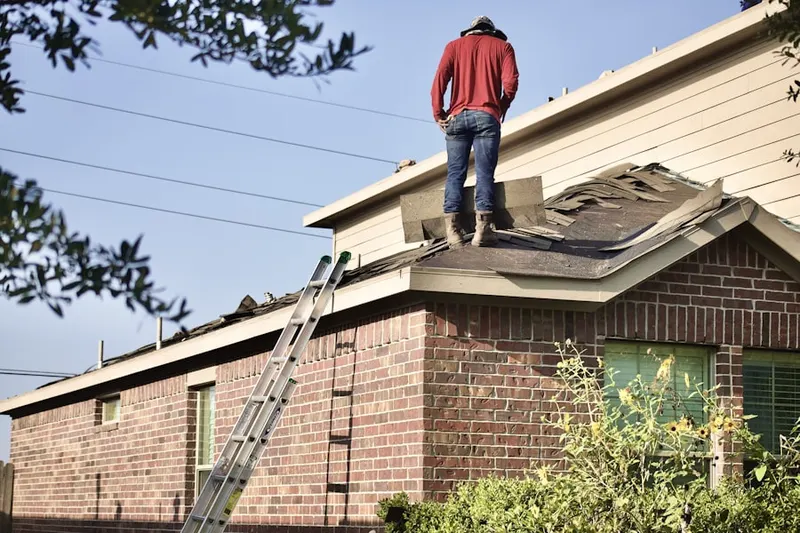 Professional roofer working on a residential roof in Wolf Creek Village